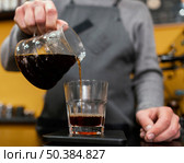 male barista pouring coffee transparent glass. Стоковое фото, агентство Ingram Publishing / Фотобанк Лори