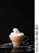 coffee cup with whipped cream black surface. Стоковое фото, агентство Ingram Publishing / Фотобанк Лори