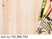 fish bobber hook fishing lure fishing line plier wooden desk. Стоковое фото, агентство Ingram Publishing / Фотобанк Лори