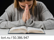 front view woman with bible praying. Стоковое фото, агентство Ingram Publishing / Фотобанк Лори