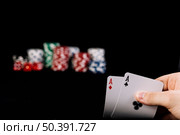 close up player s hand holding two aces playing cards. Стоковое фото, агентство Ingram Publishing / Фотобанк Лори