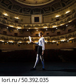 female mime reading manuscript empty auditorium. Стоковое фото, агентство Ingram Publishing / Фотобанк Лори