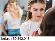 female visagiste putting makeup client. Стоковое фото, агентство Ingram Publishing / Фотобанк Лори