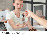 front view man accepting keys new house. Стоковое фото, агентство Ingram Publishing / Фотобанк Лори