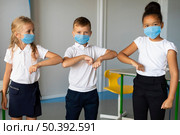 medium shot kids elbow bumping. Стоковое фото, агентство Ingram Publishing / Фотобанк Лори