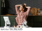 medium shot woman tying her hair indoors. Стоковое фото, агентство Ingram Publishing / Фотобанк Лори
