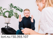 sad young man discussing her problems with female psychologist clinic. Стоковое фото, агентство Ingram Publishing / Фотобанк Лори