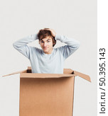 Portrait of a handsome young man inside a cardbox. Стоковое фото, агентство Ingram Publishing / Фотобанк Лори