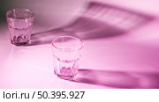 empty glasses with dark shadow pink background. Стоковое фото, агентство Ingram Publishing / Фотобанк Лори