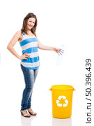 Beautiful young woman doing recycling, isolated over white background. Стоковое фото, агентство Ingram Publishing / Фотобанк Лори