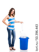 Beautiful young woman doing recycling, isolated over white background. Woman recycling. Стоковое фото, агентство Ingram Publishing / Фотобанк Лори