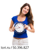 Causal young woman holding a clock, isolated over a white background. Стоковое фото, агентство Ingram Publishing / Фотобанк Лори
