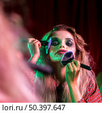 woman using multiple brushes her face. Стоковое фото, агентство Ingram Publishing / Фотобанк Лори