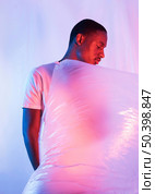 man posing with plastic foil. Стоковое фото, агентство Ingram Publishing / Фотобанк Лори
