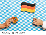 man woman holding pretzel flag. Стоковое фото, агентство Ingram Publishing / Фотобанк Лори