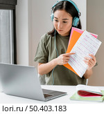 woman with headphones having video call laptop 2. Стоковое фото, агентство Ingram Publishing / Фотобанк Лори
