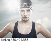 Outddor portrait od Young athletic swimer woman with googles and swimming cap, with sky on the back. Стоковое фото, агентство Ingram Publishing / Фотобанк Лори