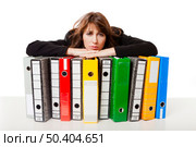 Exhausted woman in the office resting over  the folders, isolated on white background. Стоковое фото, агентство Ingram Publishing / Фотобанк Лори