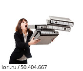 Woman in the office stumbling with a pile of folders in the hands, isolated on white. Стоковое фото, агентство Ingram Publishing / Фотобанк Лори