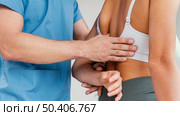 male osteopathic therapist checking female patient s scapula bone. Стоковое фото, агентство Ingram Publishing / Фотобанк Лори