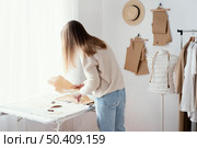 female tailor studio with clothes. Стоковое фото, агентство Ingram Publishing / Фотобанк Лори