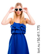 Beautiful woman in blue dress using sunglasses with a hearth shape, isolated over white background. Стоковое фото, агентство Ingram Publishing / Фотобанк Лори