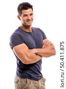 Portrait of a handsome and athletic latin man smiling with hands folded, isolated over a white background. Стоковое фото, агентство Ingram Publishing / Фотобанк Лори
