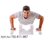Man making pushups in studio, isolated over a white background. Стоковое фото, агентство Ingram Publishing / Фотобанк Лори