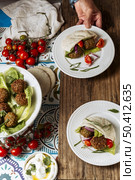 close up hand holding plate with food. Стоковое фото, агентство Ingram Publishing / Фотобанк Лори