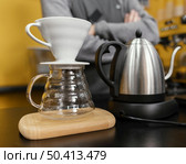 male barista preparing coffee with kettle filter. Стоковое фото, агентство Ingram Publishing / Фотобанк Лори