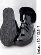 Comfortable patent leather boots. On a white background. Стоковое фото, агентство Ingram Publishing / Фотобанк Лори