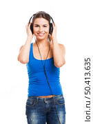 Beautiful woman listen music with headphones, isolated over a white background. Стоковое фото, агентство Ingram Publishing / Фотобанк Лори