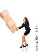 Business woman stumbling with a pile of card boxes on her hands, isolated on white. Стоковое фото, агентство Ingram Publishing / Фотобанк Лори