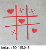 tic tac toe game with red ornament hearts. Стоковое фото, агентство Ingram Publishing / Фотобанк Лори