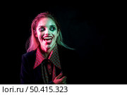 woman dressed as joker laughing hysterically. Стоковое фото, агентство Ingram Publishing / Фотобанк Лори