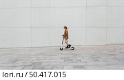young woman riding electric scooter 14. Стоковое фото, агентство Ingram Publishing / Фотобанк Лори