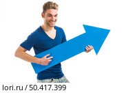 Good looking young man holding a blue arrow, isolated on a white background. Стоковое фото, агентство Ingram Publishing / Фотобанк Лори