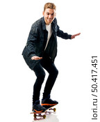 Studio portrait of a young man posing with a skateboard. Стоковое фото, агентство Ingram Publishing / Фотобанк Лори