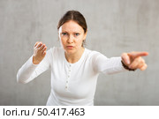 Indignant adult woman girl gesturing in studio. Стоковое фото, фотограф Яков Филимонов / Фотобанк Лори