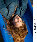 cute little girl having fun slide. Стоковое фото, агентство Ingram Publishing / Фотобанк Лори