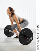 full shot woman training with dumbbell. Стоковое фото, агентство Ingram Publishing / Фотобанк Лори