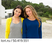 Two happy and beautiful teenage students in the school . Стоковое фото, агентство Ingram Publishing / Фотобанк Лори