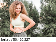 close up young female athlete having pain her waist. Стоковое фото, агентство Ingram Publishing / Фотобанк Лори
