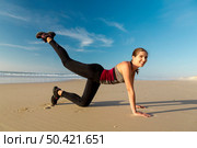 Shoot of a beautiful woman exercising herself in the beach. Стоковое фото, агентство Ingram Publishing / Фотобанк Лори