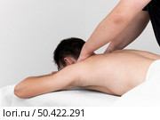 physiotherapist performing back massage man. Стоковое фото, агентство Ingram Publishing / Фотобанк Лори