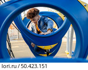 boy having fun playground outside. Стоковое фото, агентство Ingram Publishing / Фотобанк Лори
