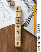 finance word wooden cubes arrangement. Стоковое фото, агентство Ingram Publishing / Фотобанк Лори