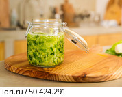 Preparing fermented preserved vegetables. Jars of cabbage kimchi and sauerkraut sour cabbage. . Стоковое фото, агентство Ingram Publishing / Фотобанк Лори