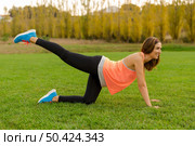 An attractive woman exercising outdoor on a soccer field. Стоковое фото, агентство Ingram Publishing / Фотобанк Лори
