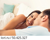Young couple on bed and having a good time. Стоковое фото, агентство Ingram Publishing / Фотобанк Лори